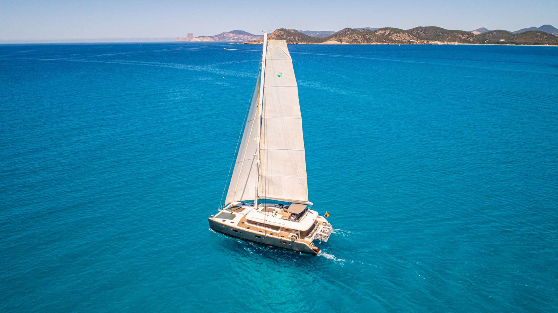 Firefly Crewed Lagoon 620 Catamaran Charter Sailing in the Balearics