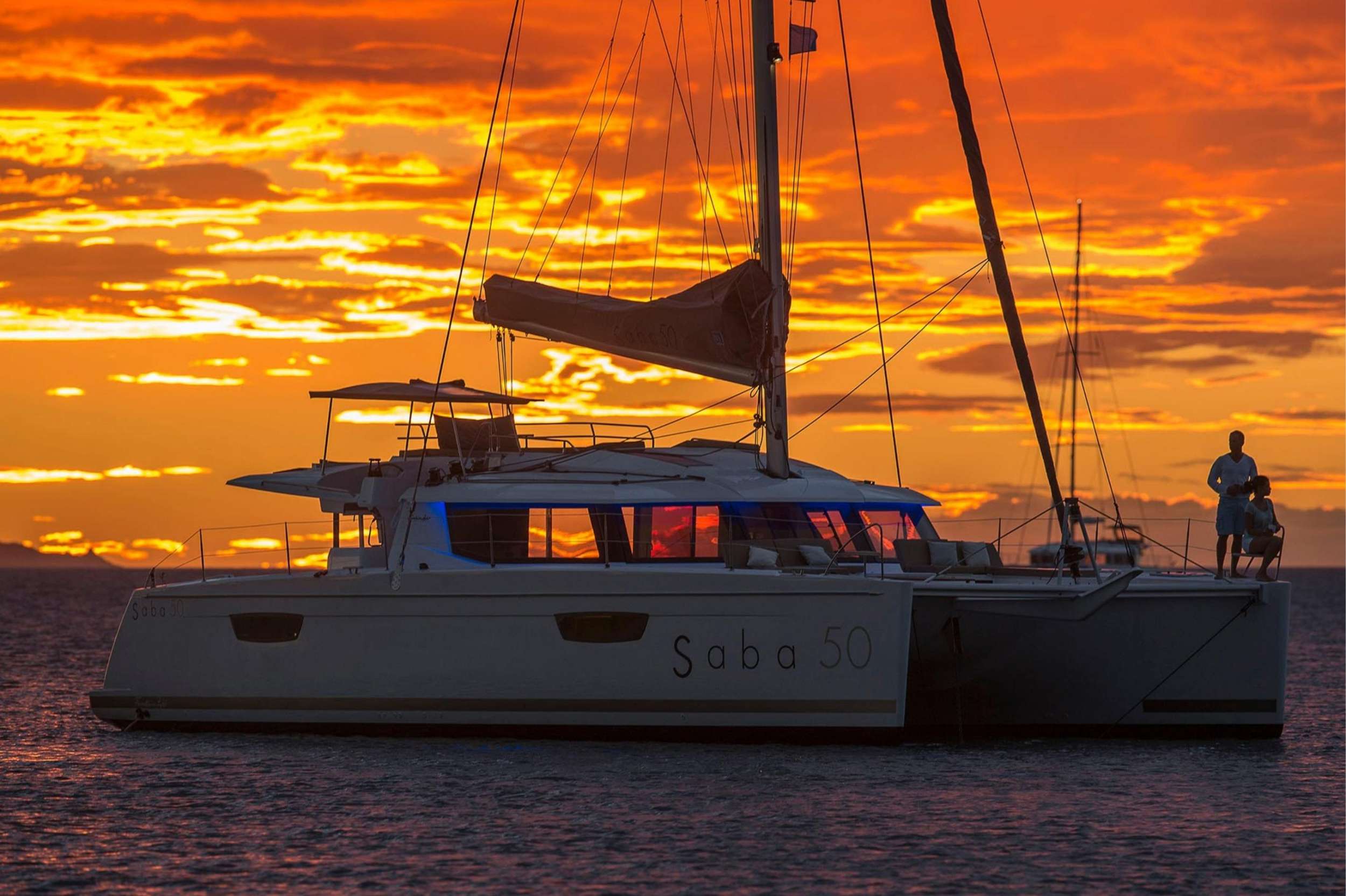 Discover Crewed Catamaran Charter Anchored for Sunset in Belize